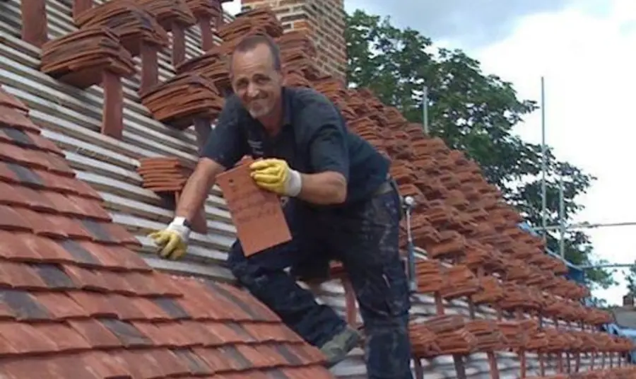 A man retiling the roof at Finchingfield