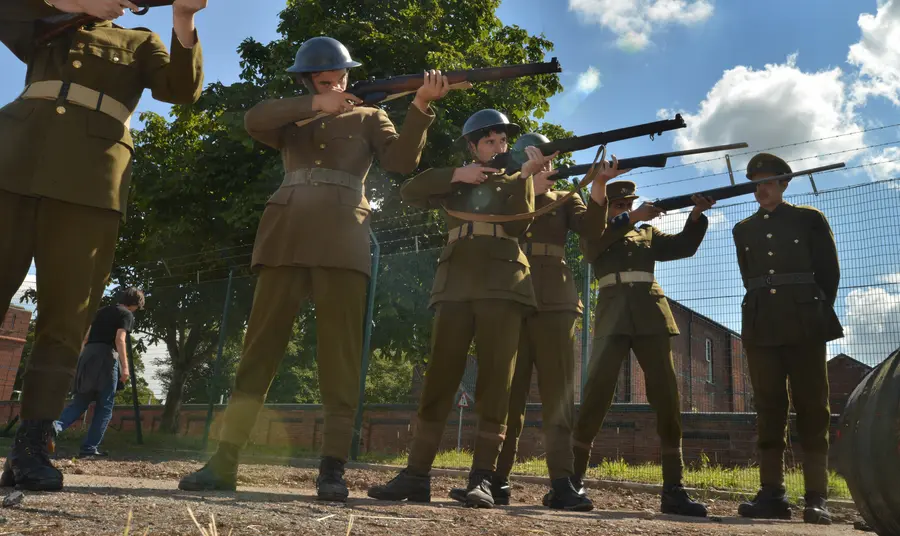 Men line up with guns to execute a soldier for cowardice. A still from ‘After Dawn’, the film created by young people at Central Youth Theatre.