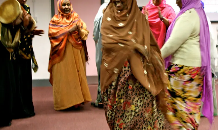 A group of people from Granby Somali Women's group stand in a circle