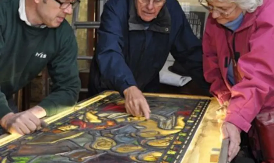 Participants examining a stained glass window at All Saint’s Church, Silkstone