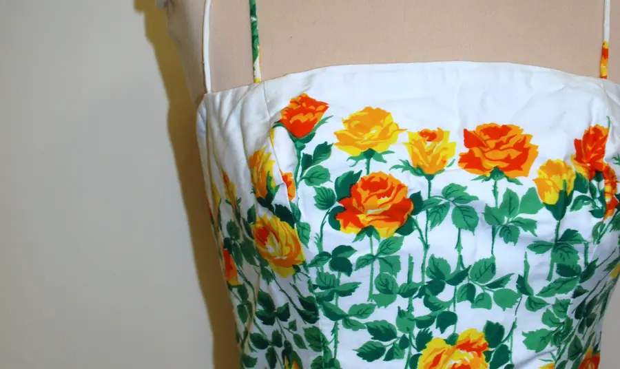 A close up of a white dress with floral pattern