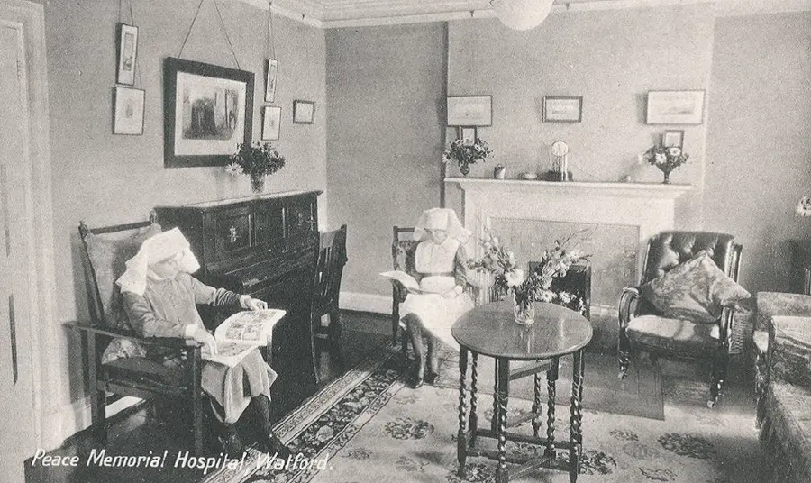 Archive image of nurses relaxing and reading in a sitting room at the Peace Hospice