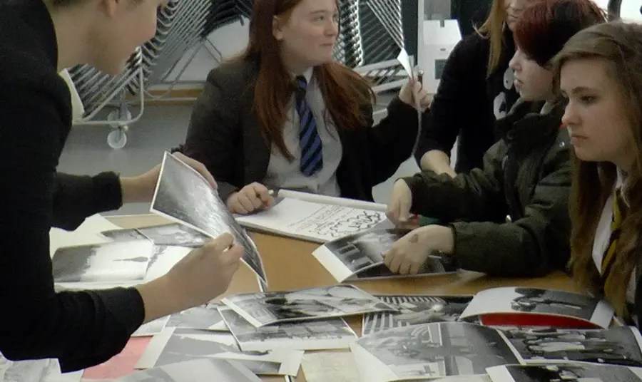 Students look at historic photographs