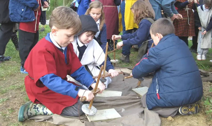 Children exploring historic tools as part of the project