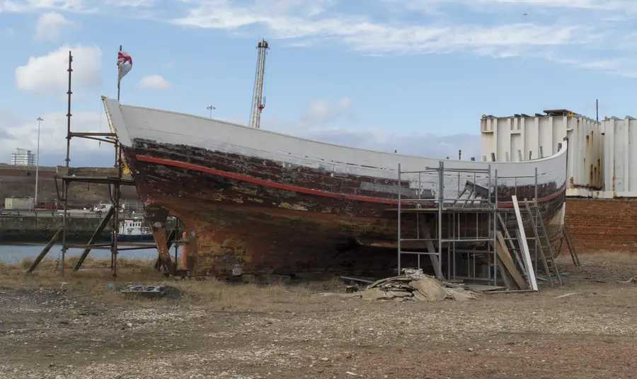 The hull of a boat being repainted