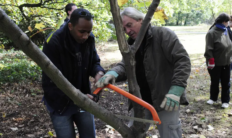 Trainer showing participant how to prune a tree