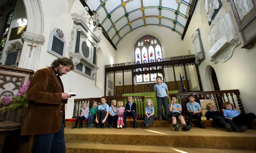 A group visiting St Swithun’s Church, Sandford