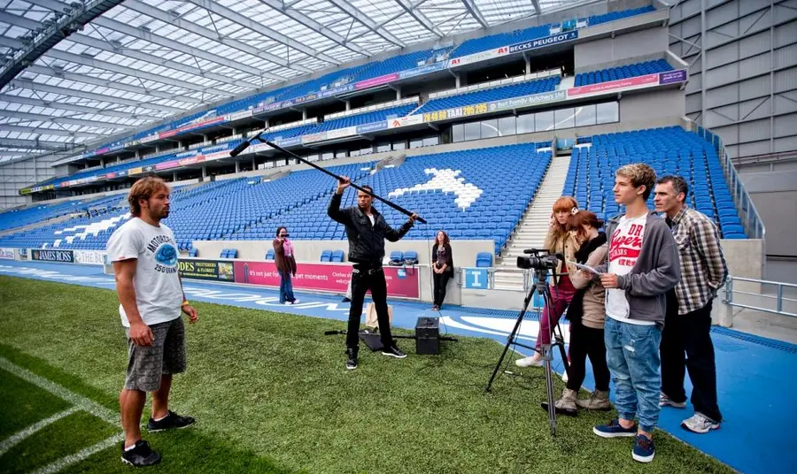 Young people filming in a sports environment