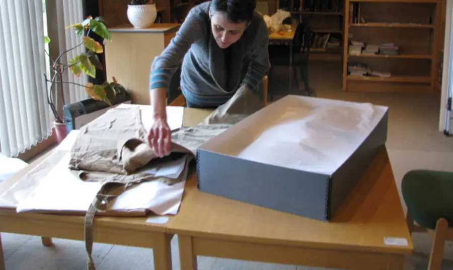 Examining one of the Land Girl's uniforms 