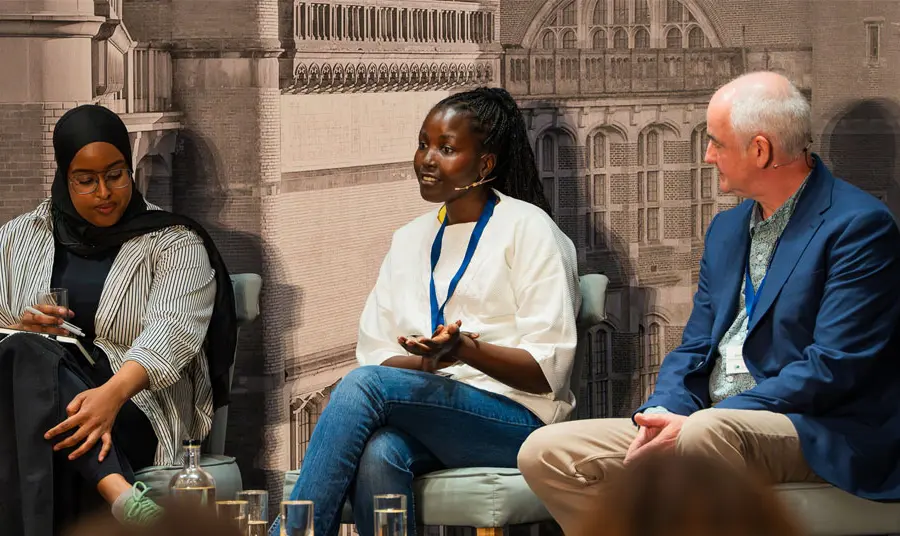 Three people participate in a panel discussion