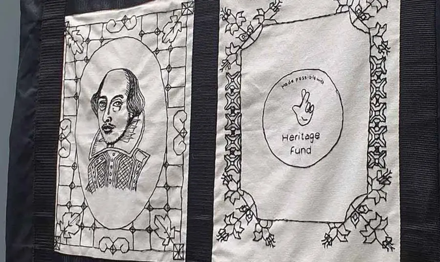 Two black and white embroidered banners. One features a portrait of William Shakespeare and the other shows The National Lottery Heritage Fund acknowledgement stamp.