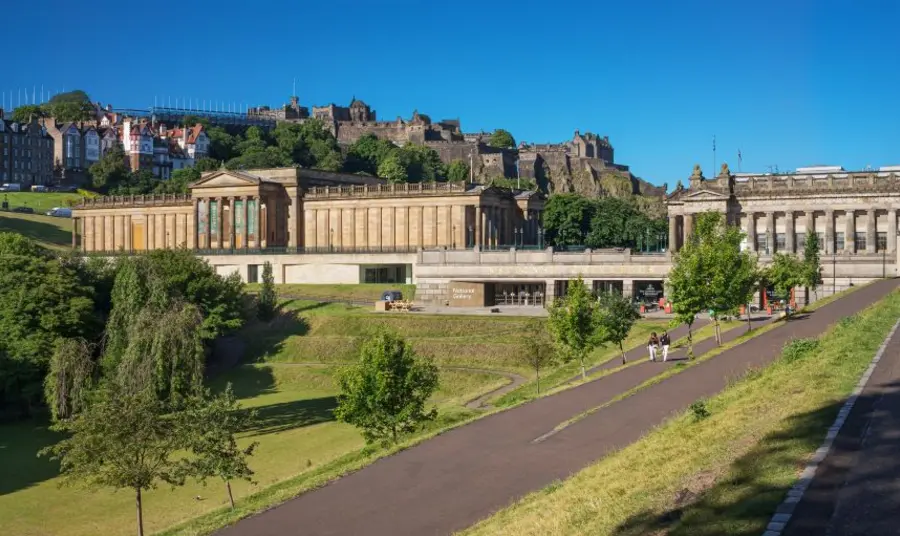 The grand neoclassical facade of the National sits atop the Mound in the centre of Edinburgh, looking out over the greenery of Princes Street Gardens.