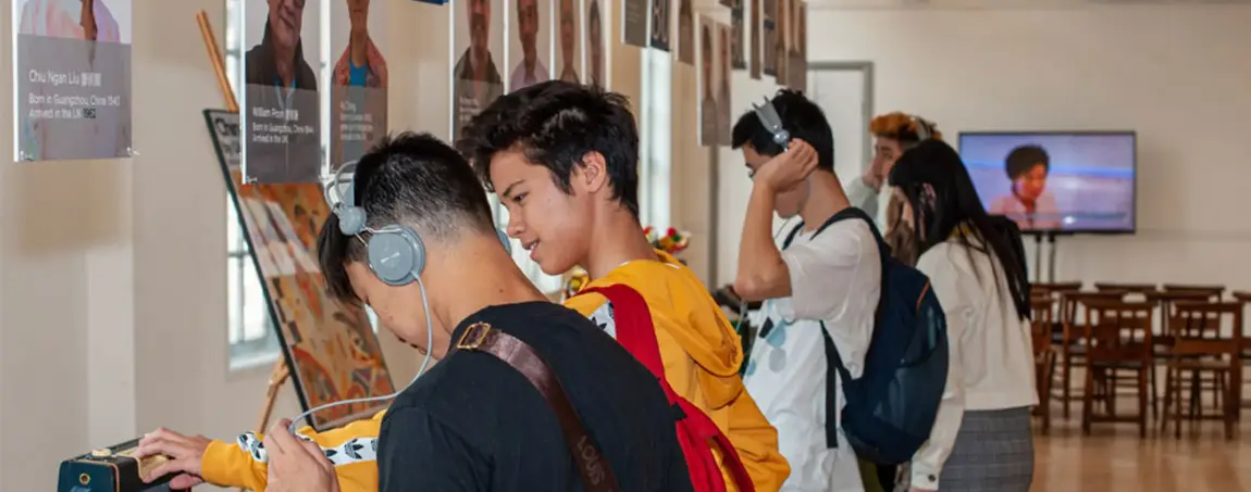 a couple of chinese young people look at an exhibition