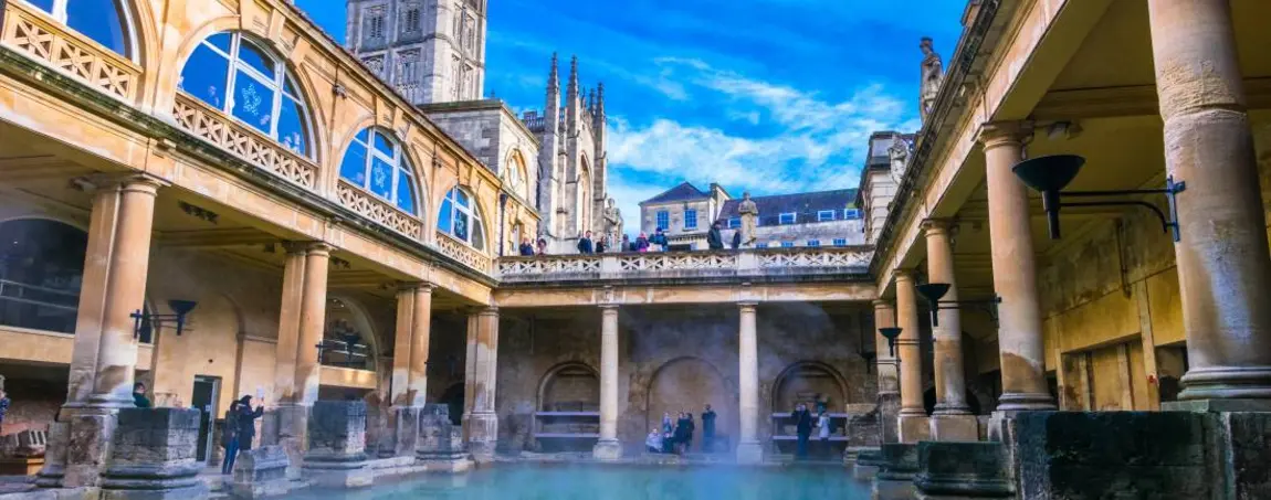 View of The Great Bath in Bath, Somerset, showing the water surrounded by Roman architecture. 