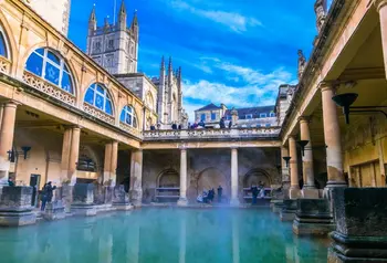 View of The Great Bath in Bath, Somerset, showing the water surrounded by Roman architecture.