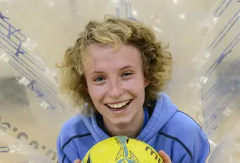 Danielle Pointon in a zorb with a football