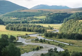 Tomintoul and Glenlivet landscape with a river, woodland and mountain backdrop