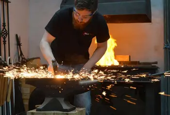 A blacksmith striking metal, with sparks flying