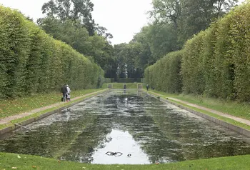 Large pond surrounded by hedges