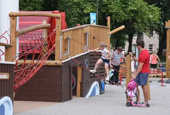 Family playing on playpark structures.