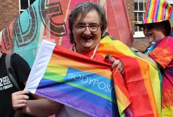 Woman with rainbow flag at Chester Pride