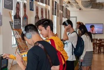 Young people engage in the exhibition and listen to the interviews on a headset