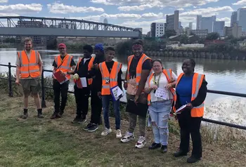 Group of young people standing in front of river