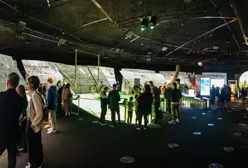 People inside building looking at exhibits