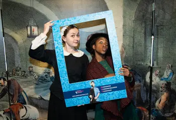 Image of two people in historic nursing outfits depicting Mary Seacole and Florence Nightingale, holding a frame to their faces