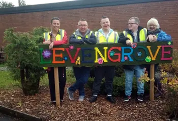 Group stand around park sign