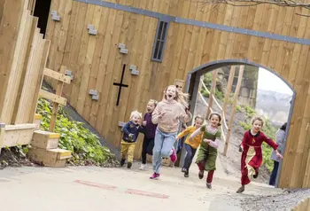 Children running through large arch