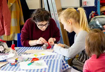 Woman making crafts with children