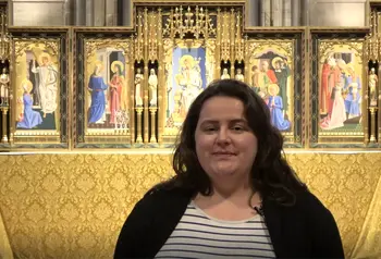 Person stood in Hereford Cathedral. They are talking to the camera.