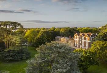 An ariel view of Boston Manor in its parkland with lawns and trees