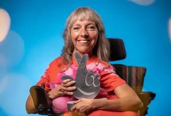 Esther Fox holding a metallic cross-fingers award