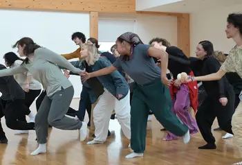 A group of people are in a studio taking part in a movement and dance workshop