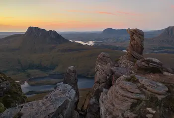 Rugged landscape at sunset including mountains and jagged rocks in the Scottish uplands