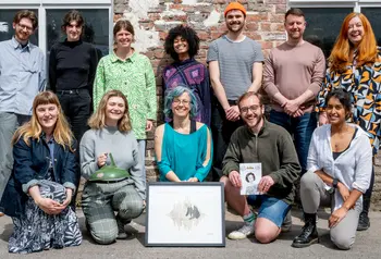 A group of people stand together with the Delia Derbyshire collections