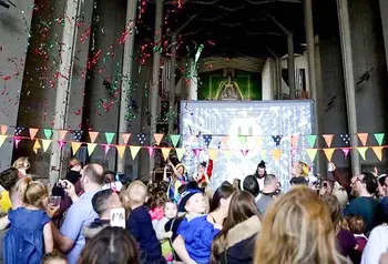 a crowd at a celebration event inside coventry cathedral