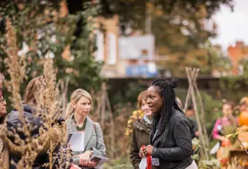 A woman leading a group tour at the Chelsea Physic Garden.