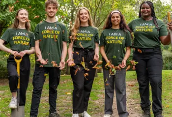 Five young people standing in a row wearing matching T-shirts that say 'I am a force of nature'