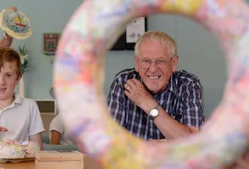 An older and younger participant at a workshop