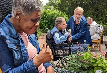 Adults with complex care needs in a garden