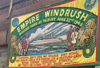 A colourful banner commemorating the landing of the Empire Windrush, saying 'Docked here at Tilbury, June 22nd 1948'