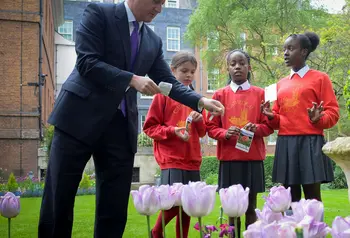 The Prime Minister planting poppy seeds with local school children