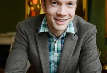 Chris Ferguson sits at a table