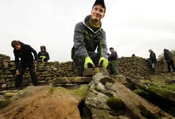 A trainee working on a dry stone wall