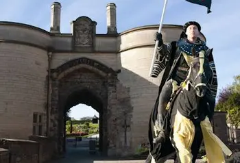 A horseman in costume rides out of Nottingham Castle