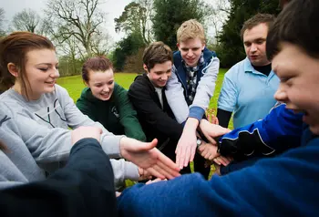 Young people teambuilding in a park