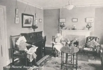 Archive image of nurses relaxing and reading in a sitting room at the Peace Hospice